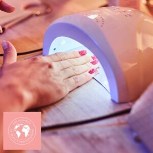 Gel Polish Course Manual a hand under a setting lamp for gel nails