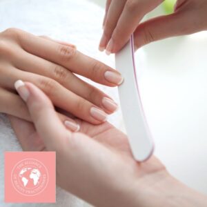 Manicure Course Manual - close up of lady's nail being professionally filed