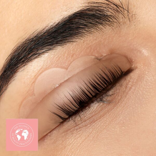 A close up of a lady's eye during an eyelash lift and tint beauty course session